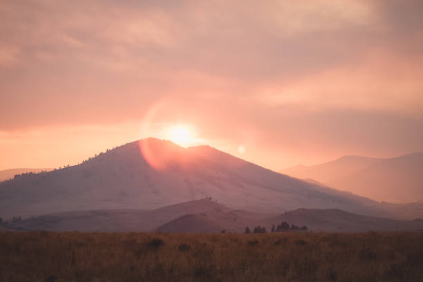 Amazing sunset with orange sky and clouds over the hills. Idaho, USA