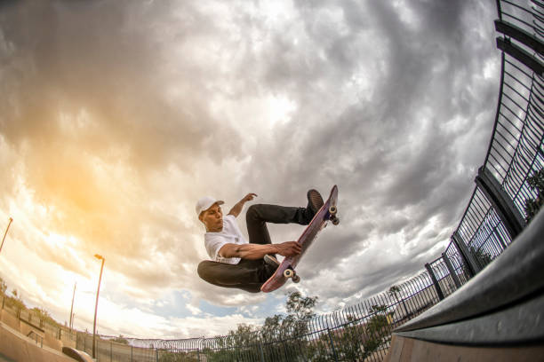 Skateboarding Skateboarding trick. Photographed using the Canon EOS 1DX mark II and the 15mm fisheye lens fish eye lens photos stock pictures, royalty-free photos & images
