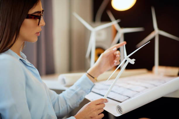 istock Buinesswoman holding windmill model. 1176804522