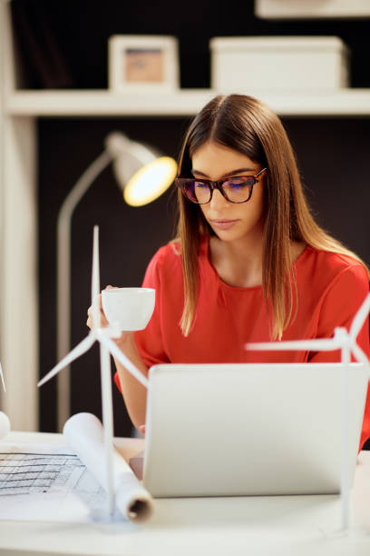 istock Woman drinking coffee in office. 1176805026