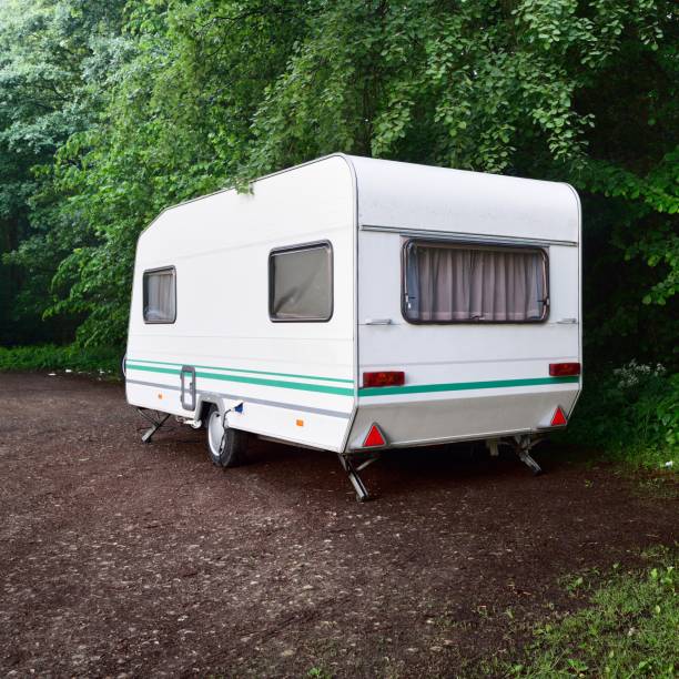 istock Caravan trailer on a forest road, on a summer day 1176805745