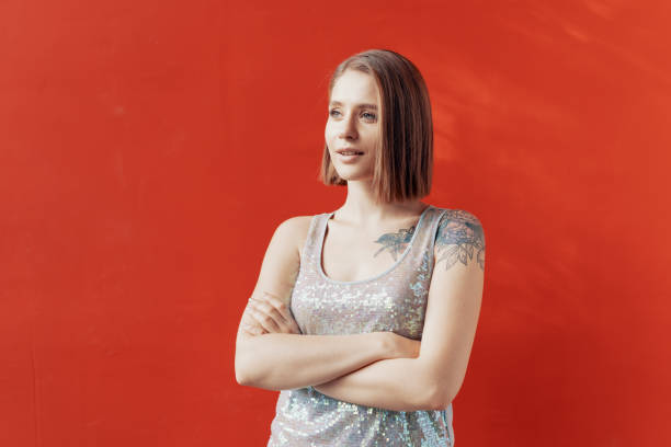 istock Cheerful young girl posing in front of a red wall 1176806066