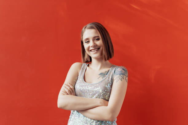 istock Cheerful young girl posing in front of a red wall 1176806080