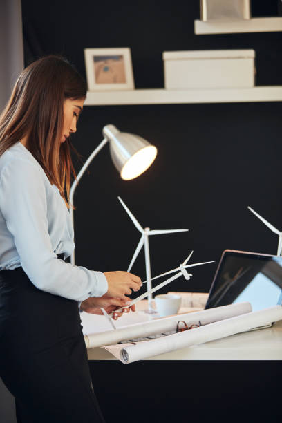 istock Businesswoman standing in office and working on project. Sustainable development concept. 1176806299