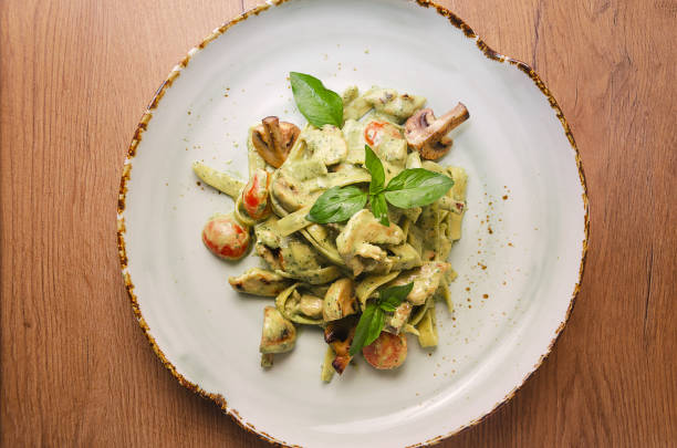 istock green pasta with chicken, basil and mushrooms 1176807029
