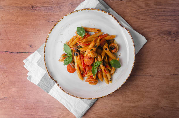istock Italian Pasta with shrimp in tomato sauce 1176807682