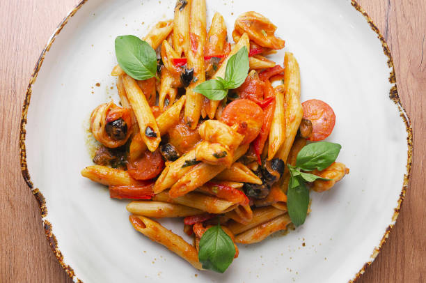 istock Italian Pasta with shrimp in tomato sauce 1176807760