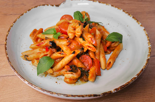 istock Italian Pasta with shrimp in tomato sauce 1176807779