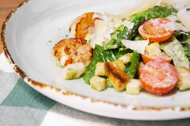 istock Shrimp Caesar salad with Parmesan cheese, croutons and lettuce 1176808286