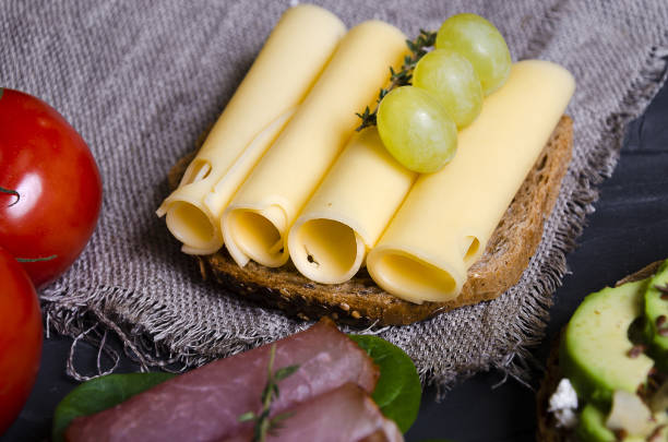 istock sandwiches with various fillings: ham, cheese, avocado, sauce 1176808840