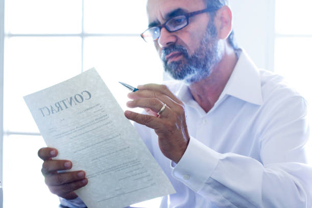 istock Hispanic Man Reviewing A Contract 1176810617