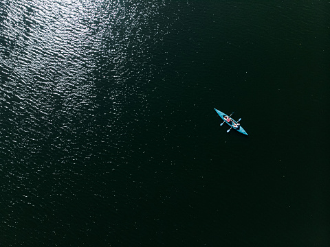 A drone shooting a kayak floating in the water.