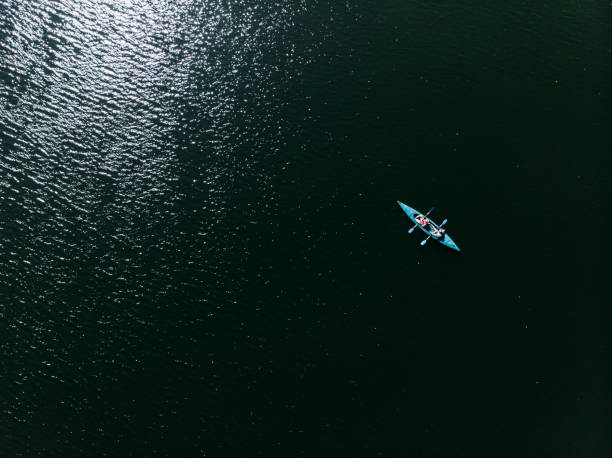 a drone shooting a kayak floating in the water. - rowboat river lake nautical vessel imagens e fotografias de stock