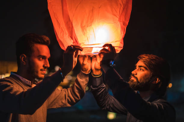 istock Two Indian young men launching a Chinese sky fly fire lantern to make a wish in Udaipur, India 1176811669