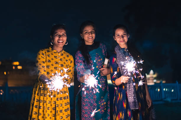 istock Three young Indian women with bengal fireworks, Udaipur, India 1176811671