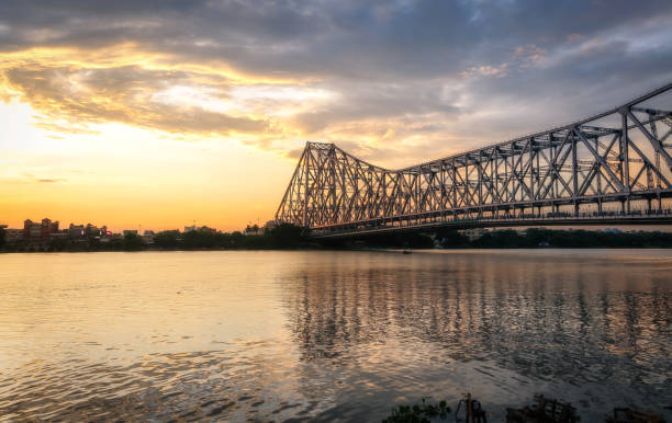 istock Howrah bridge the historic cantilever bridge on river Ganges at Kolkata at twilight with moody sky 1176811701