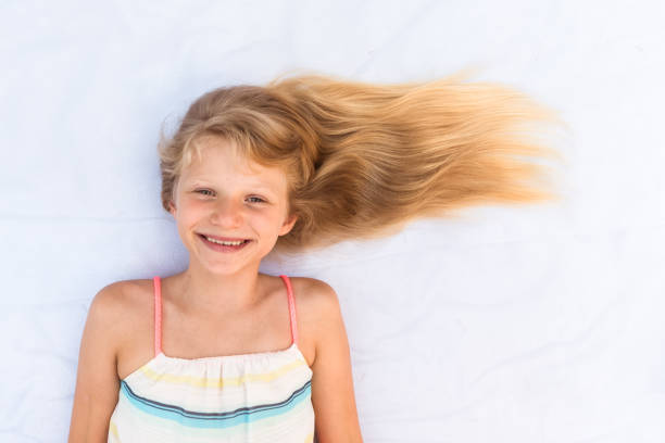 istock charming smiling young child long blond hair copy space 1176813288