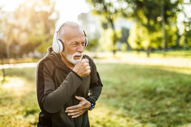 Sporty senior man coughing. Sporty senior man coughing. human cardiopulmonary system audio stock pictures, royalty-free photos & images