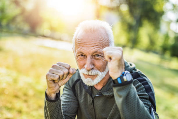 Sporty senior man loves boxing and is stronger than ever. Sporty senior man loves boxing and is stronger than ever. old man boxing stock pictures, royalty-free photos & images