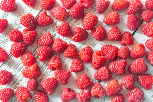 istock Fresh raspberries on the wooden background 1176815417