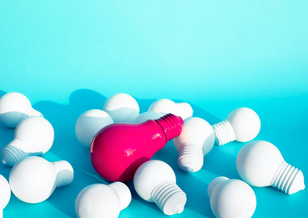 istock Ideas inspiration concepts with only one of lightbulb outstanding on another lightbulb on blue color background 1176816893