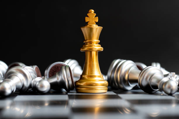 金の王チェスの作品は、黒の背景に横たわっている銀のポーンに勝つ - chess king chess chess piece black ストックフォトと画像