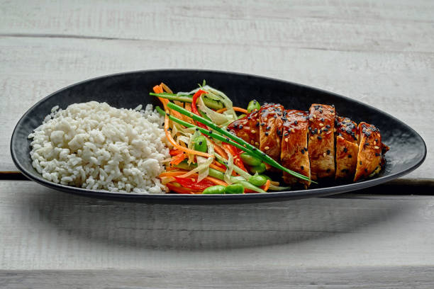 istock Teriyaki chicken with salad and rice 1176817514