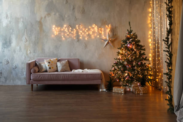 Dark loft living room decorated for Christmas with tree and lights stock photo