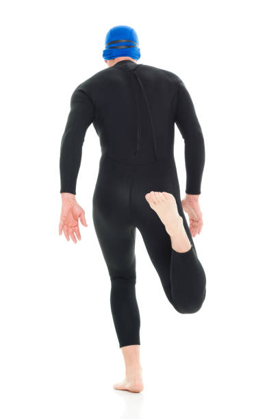 full length / one man only / one person of 30-39 years old handsome people caucasian male / mid adult men / mid adult triathlete doing triathlon / swimming / running / exercising in front of white background - swimming male isolated swimming goggles imagens e fotografias de stock