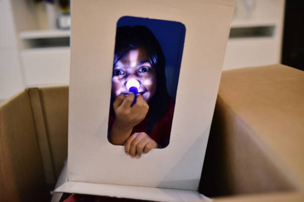 istock Girl wearing box and peeking through it 1176826871