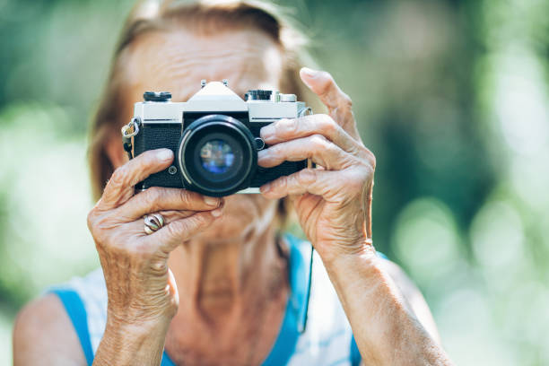 istock Elderly woman with a photo camera 1176830050