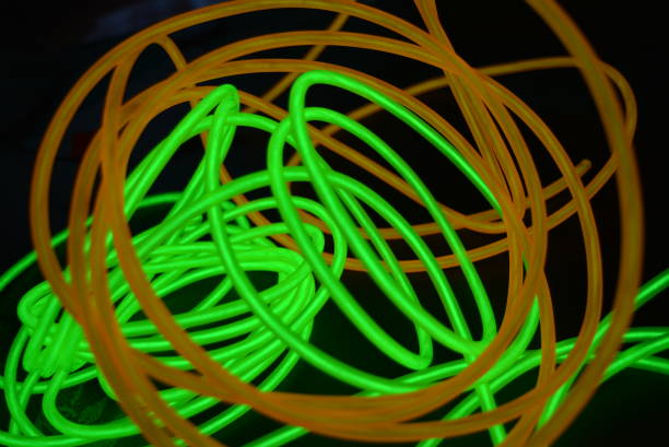 istock Bright luminous yellow and green, lime neon wires in different formats and layouts. An electroluminescent wire, a neon light guide, an ice tube are folded into different structures and shapes. 1176830505