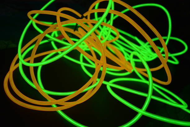 istock Bright luminous yellow and green, lime neon wires in different formats and layouts. An electroluminescent wire, a neon light guide, an ice tube are folded into different structures and shapes. 1176830581