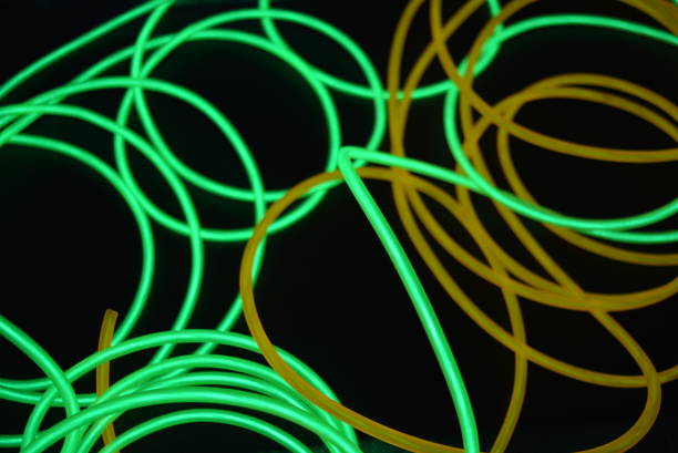 istock Bright luminous yellow and green, lime neon wires in different formats and layouts. An electroluminescent wire, a neon light guide, an ice tube are folded into different structures and shapes. 1176830662