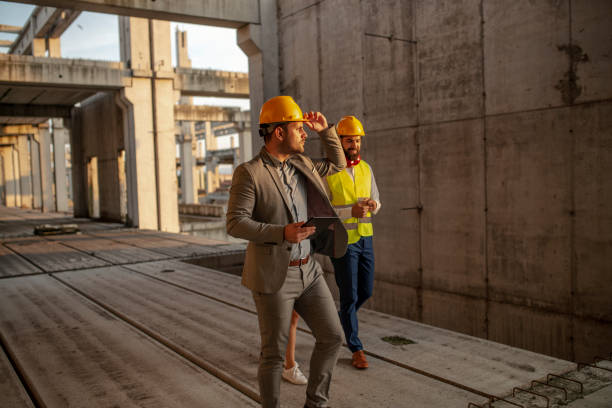 istock Group of business partners meeting on a construction site 1176835573