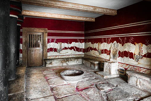 Metal sink and water taps against a yellow wall. 20th century system. Prison in Finland