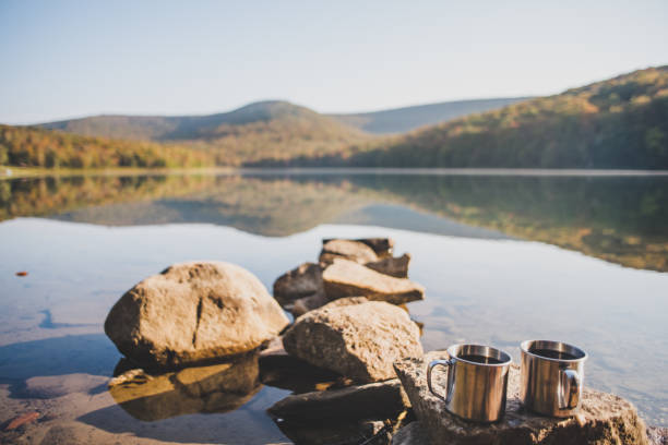 Camping And Drinking Morning Coffee near a lake stock photo