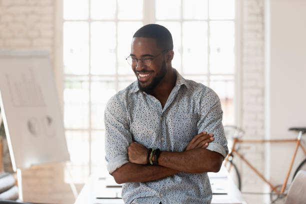 istock Happy african american businessman standing in modern work space 1176842698