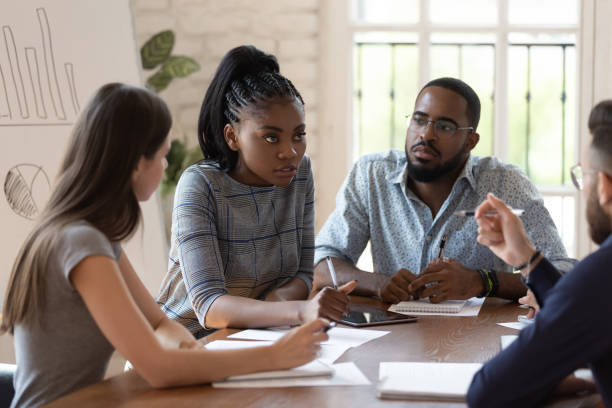 istock Focused female black executive teaching training workers at office briefing 1176842760