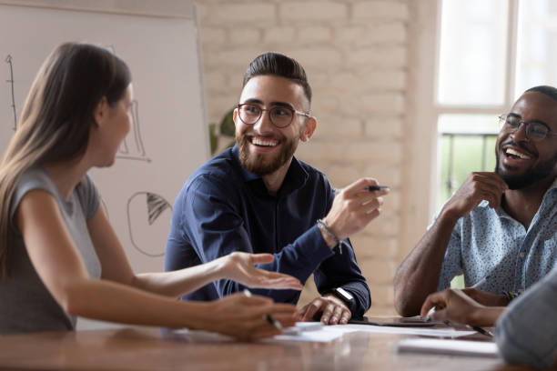istock Happy diverse creative business team people talking at group meeting 1176842761