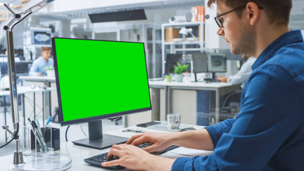 istock Over the Shoulder Shot of Engineer Working with Green Screen Mock-up Template on Desktop Computer. In the Background Engineering Facility Specialising on Industrial Design 1176842801