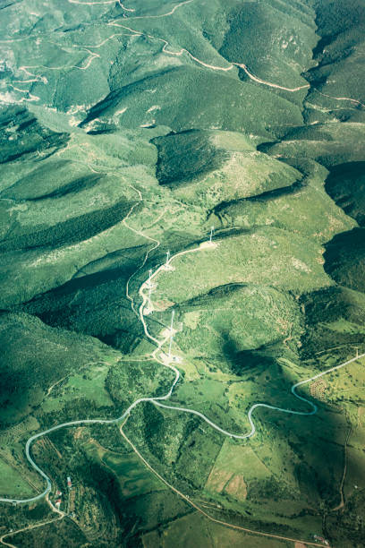 istock Aerial view of agricultural field and wind turbine 1176843607