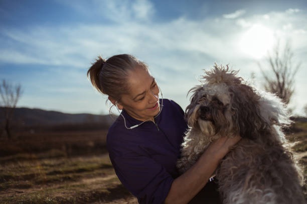 istock Senior woman playing with dog 1176843654