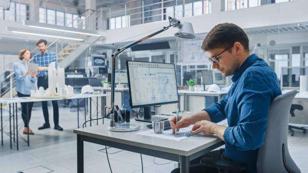 istock In Architectural Bureau: Team of Architects and Engineers Working on a Building Complex Prototype Project, Using City Model and Computers Running 3D CAD Software. Residential or Business District 1176843773