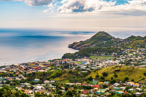 Landscape and port city of Kingstown.	Panoramic view with city, ocean, sunset sky and clouds. Cruise destination.