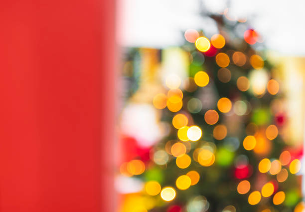 istock Christmas tree with colorful bokeh lights and red copy space 1176845544