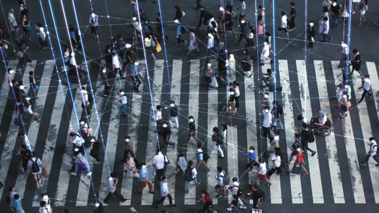 High Angle Shot of a Crowded Pedestrian Crossing in Big City. Augmented Reality Shows Visual Representation of Connected People with the Internet World, Technology Around Us and Wi-Fi  Wave Network.