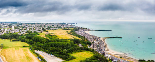 Aerial view of Cancale harbor Aerial view of Cancale harbor with residential district and agricultural field, France cancale photos stock pictures, royalty-free photos & images