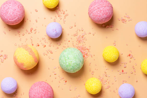 istock Colorful bath bombs and pink salt on a pastel orange background 1176846058