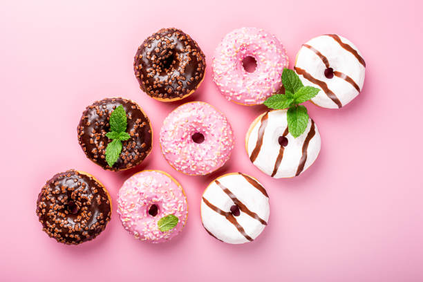istock Colorful donuts on rose background 1176846894